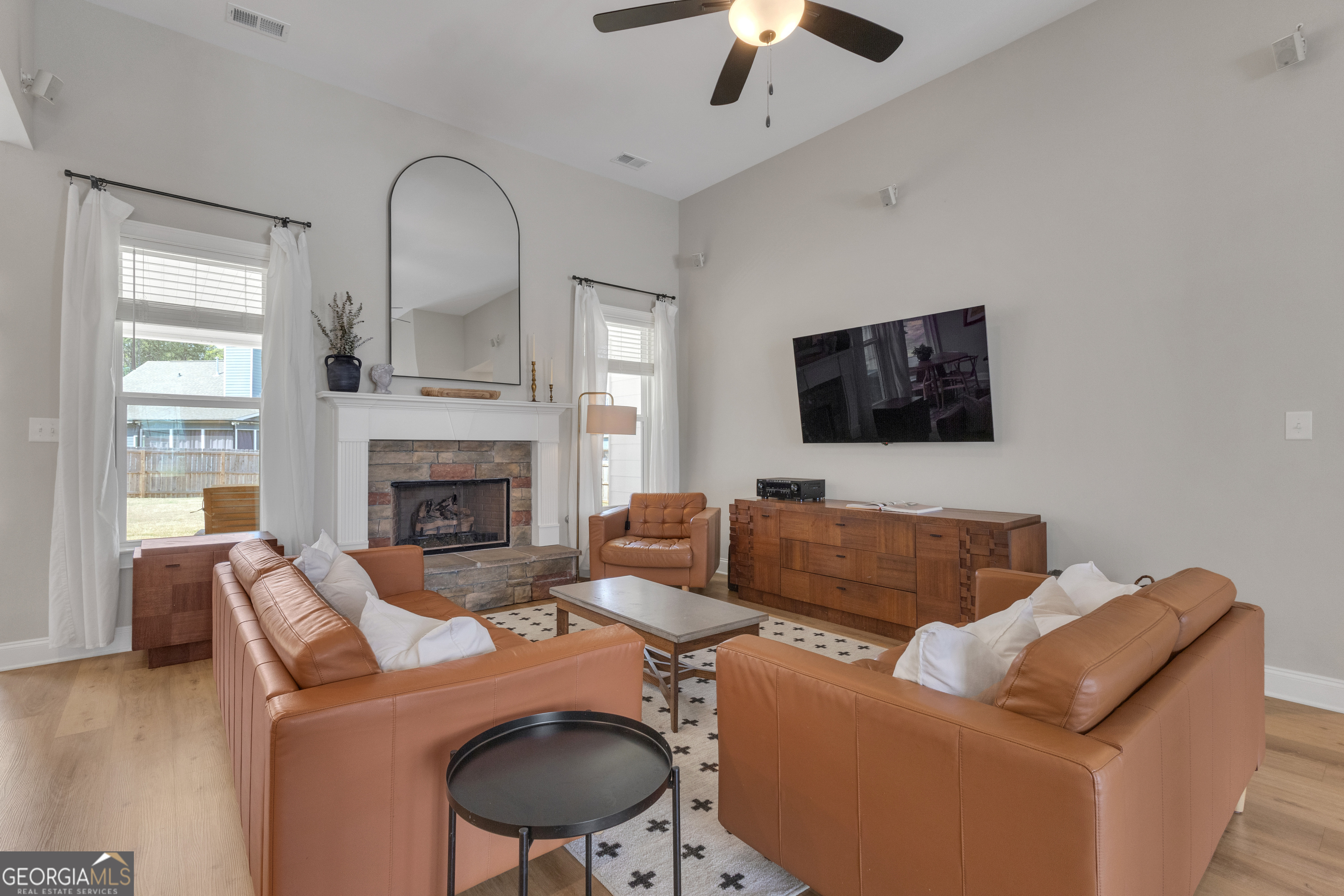 50 Cushing Street Senoia, GA 30276 - Photo 7 of 72 a living room with furniture a flat screen tv and a fireplace
