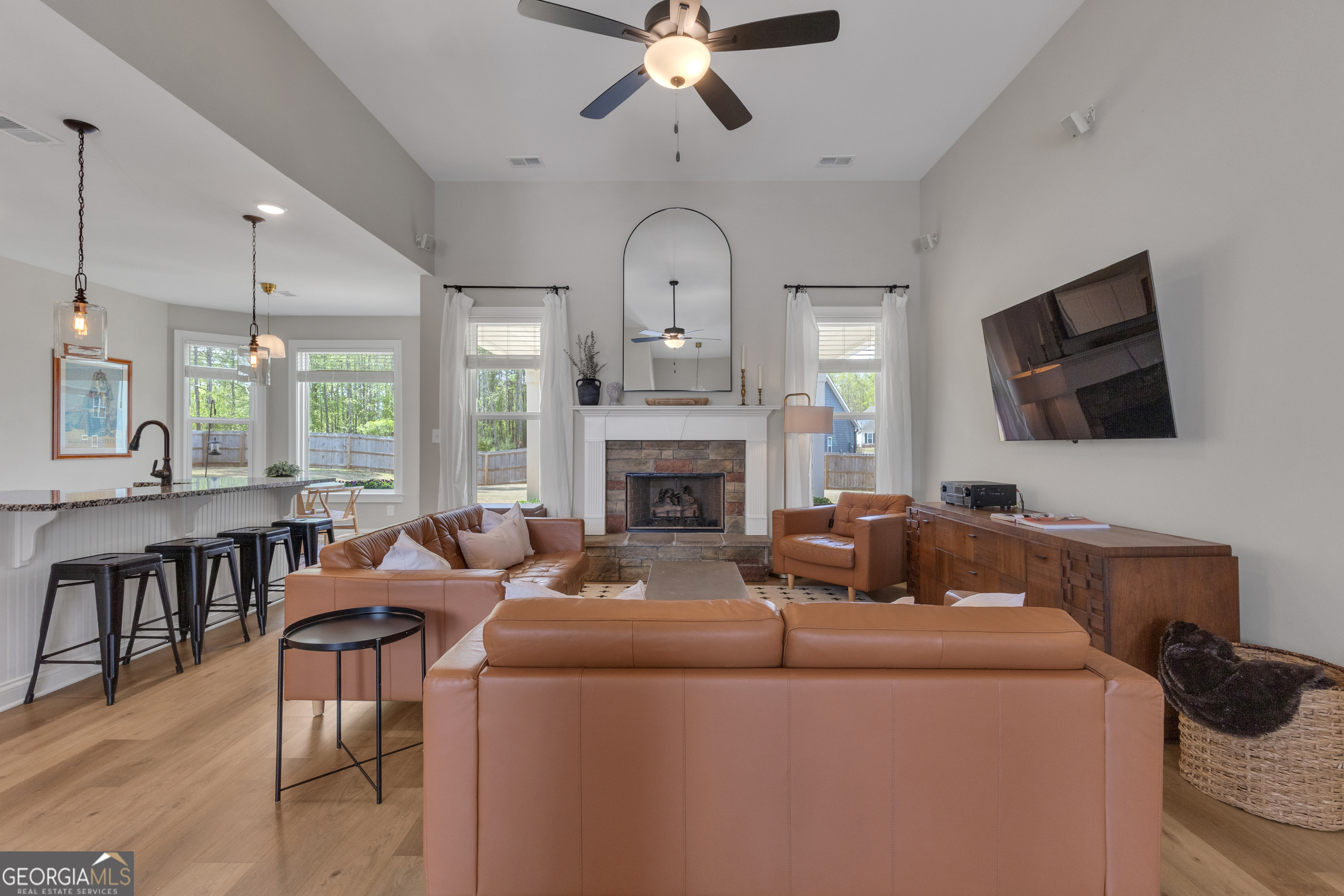 50 Cushing Street Senoia, GA 30276 - Photo 8 of 72 a living room with furniture a fireplace and a flat screen tv