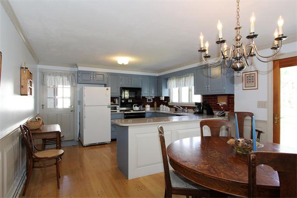 108 Boston Post Road Wayland, MA 01778 - Photo 5 of 18 a view of a dining room with furniture a kitchen and chandelier