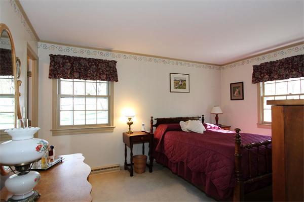 108 Boston Post Road Wayland, MA 01778 - Photo 10 of 18 a bedroom with a bed and wooden floor