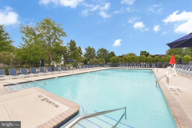 a view of a swimming pool with a lawn chairs