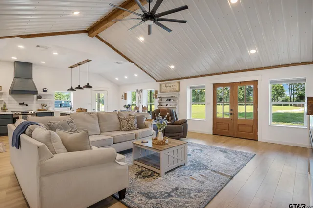 a living room with furniture and a large window