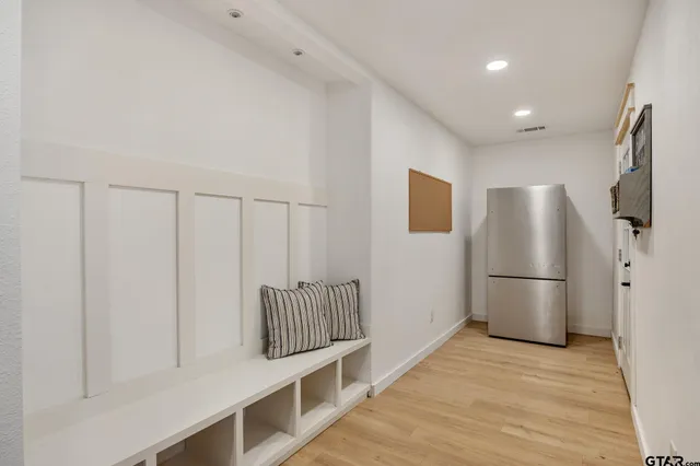 a kitchen with stainless steel appliances a refrigerator and a stove top oven
