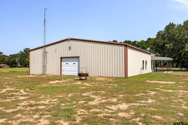 a big house with a large tree in front of it