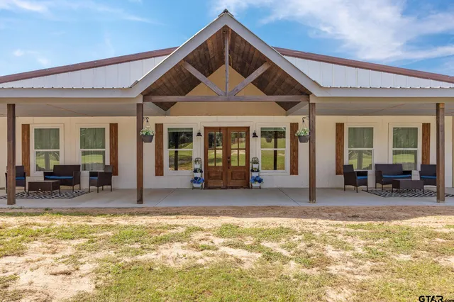 a view of a house with outdoor seating