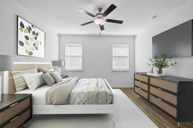 a bedroom with a large bed and a chandelier