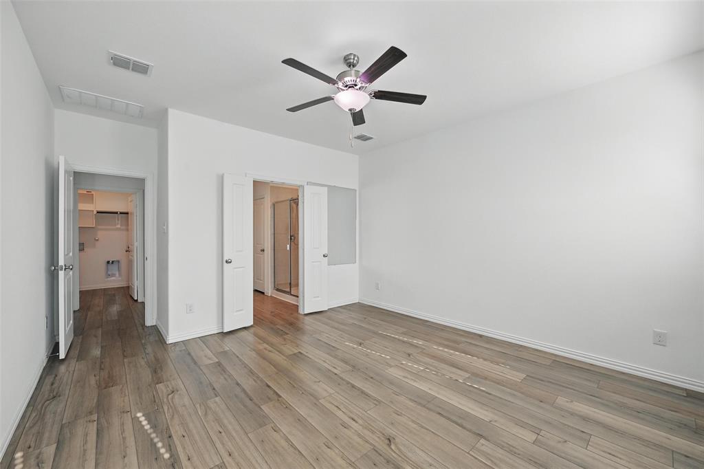 613 Chip Street Little Elm, TX 75068 - Photo 16 of 37 Unfurnished bedroom with wood finished floors and a ceiling fan