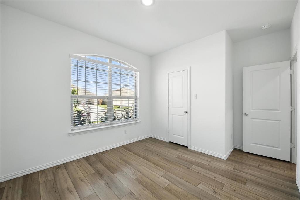 613 Chip Street Little Elm, TX 75068 - Photo 18 of 37 Unfurnished bedroom featuring light wood-style floors
