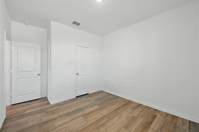 a view of a room with wooden floor
