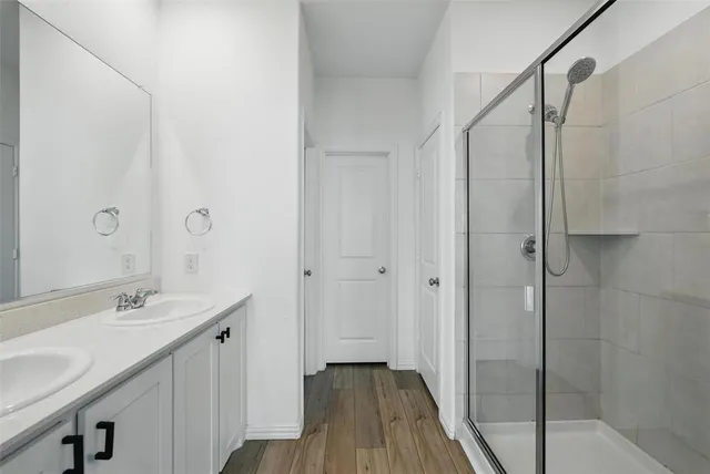 a bathroom with a double vanity sink and mirror