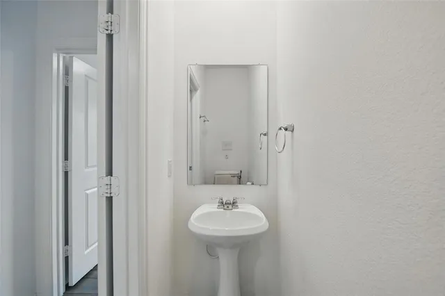 a bathroom with a sink a mirror and a shower