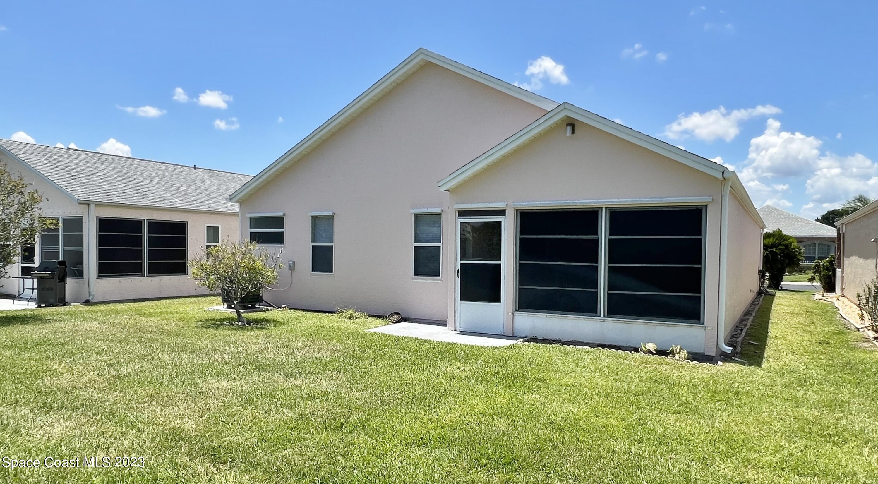 1054 South Fork Circle Melbourne, FL 32901 - Photo 11 of 16 a front view of a house with a yard and garage