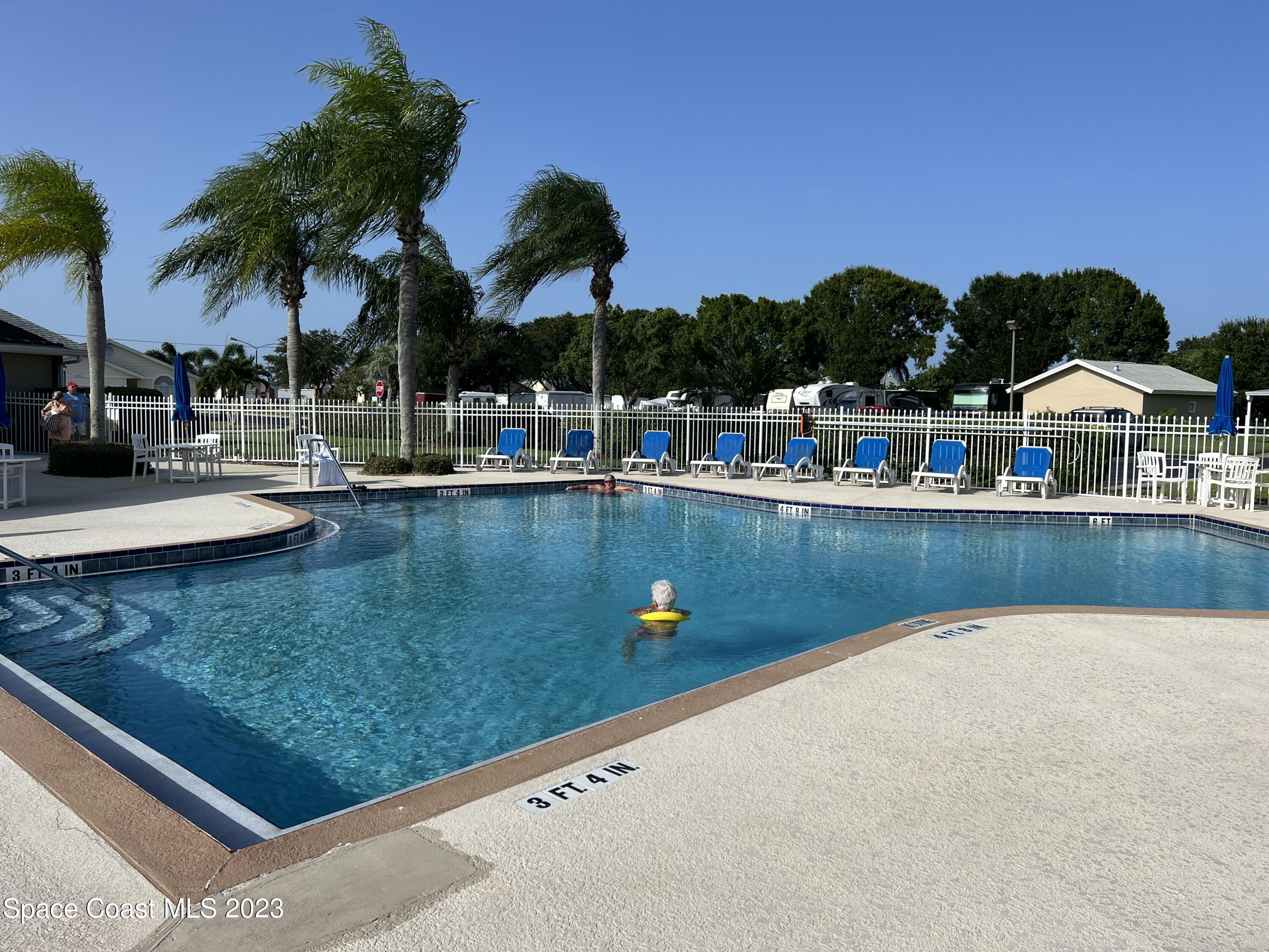 1054 South Fork Circle Melbourne, FL 32901 - Photo 14 of 16 a view of swimming pool with outdoor seating and yard