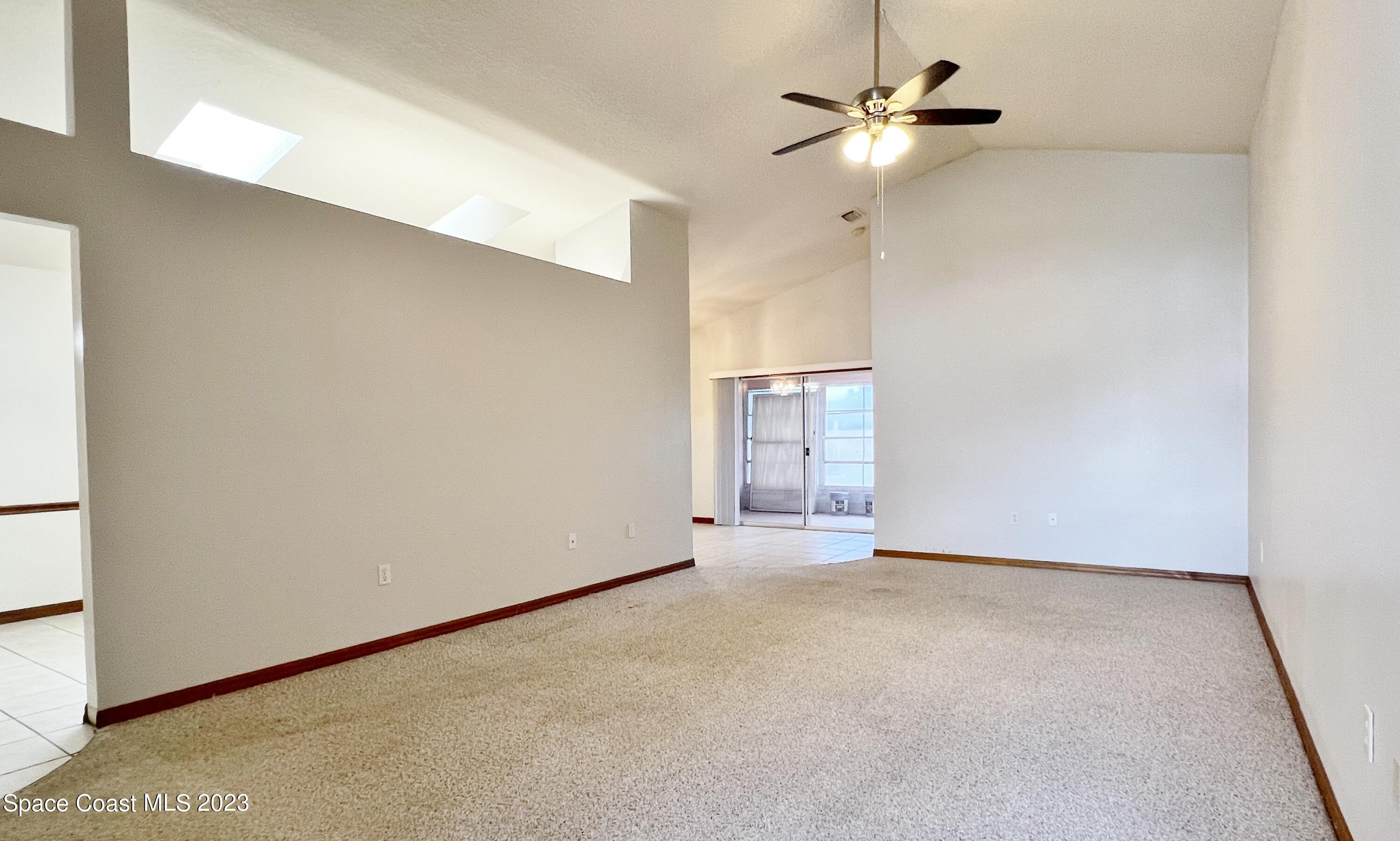 1054 South Fork Circle Melbourne, FL 32901 - Photo 2 of 16 a view of an empty room with a ceiling fan