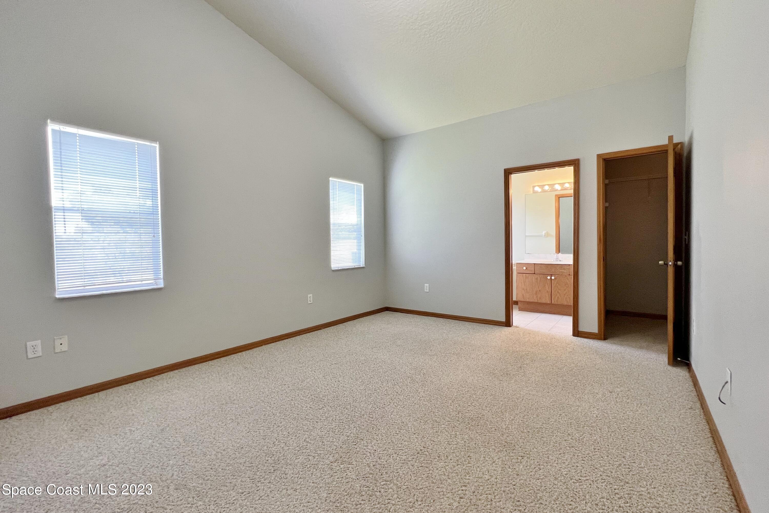 1054 South Fork Circle Melbourne, FL 32901 - Photo 4 of 16 an empty room with windows and closet