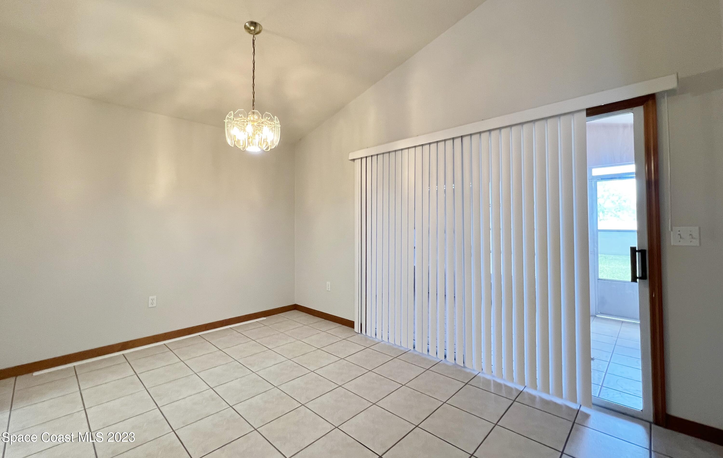 1054 South Fork Circle Melbourne, FL 32901 - Photo 6 of 16 a view of an empty room with wooden floor and a window