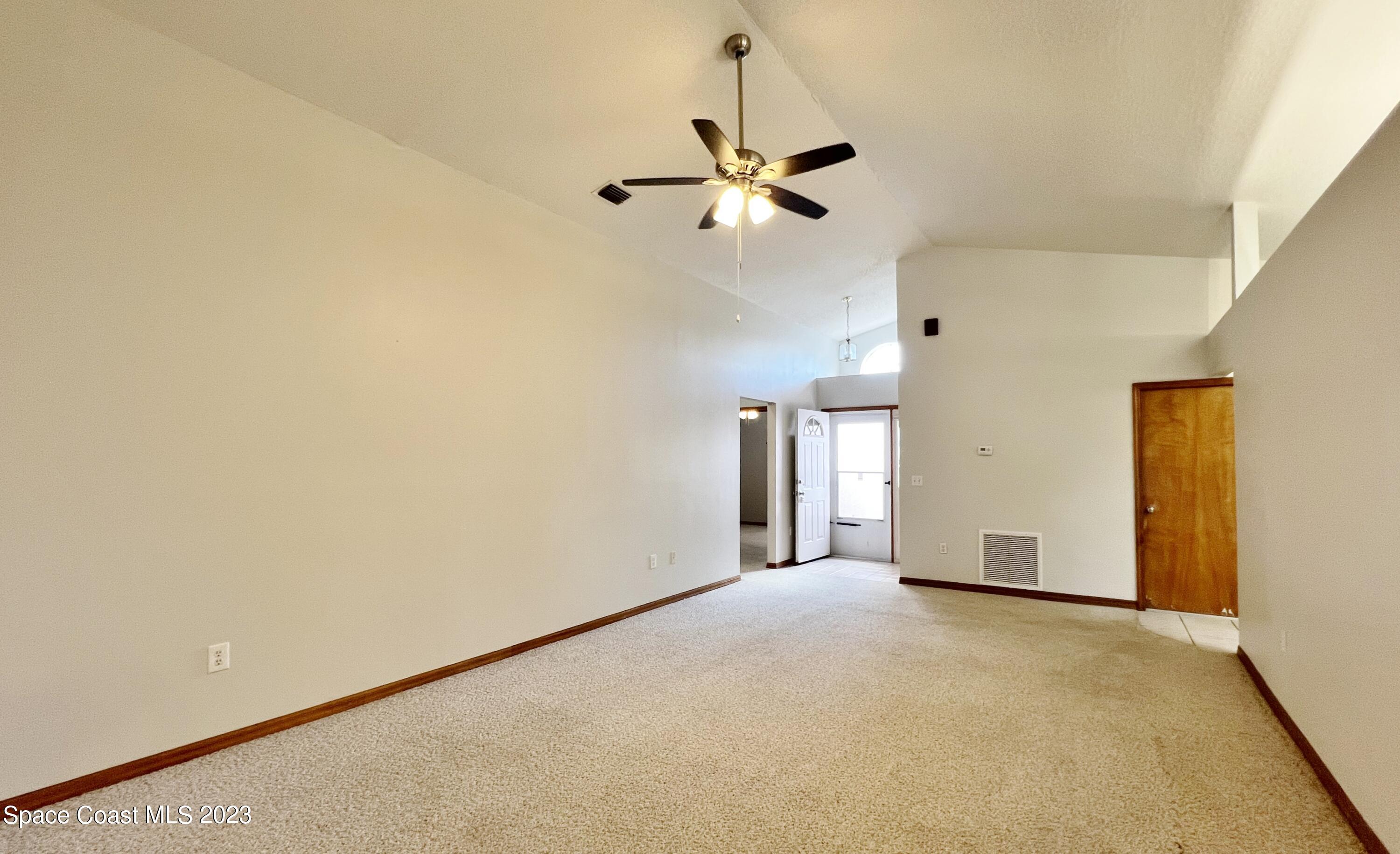 1054 South Fork Circle Melbourne, FL 32901 - Photo 7 of 16 a view of empty room with ceiling fan