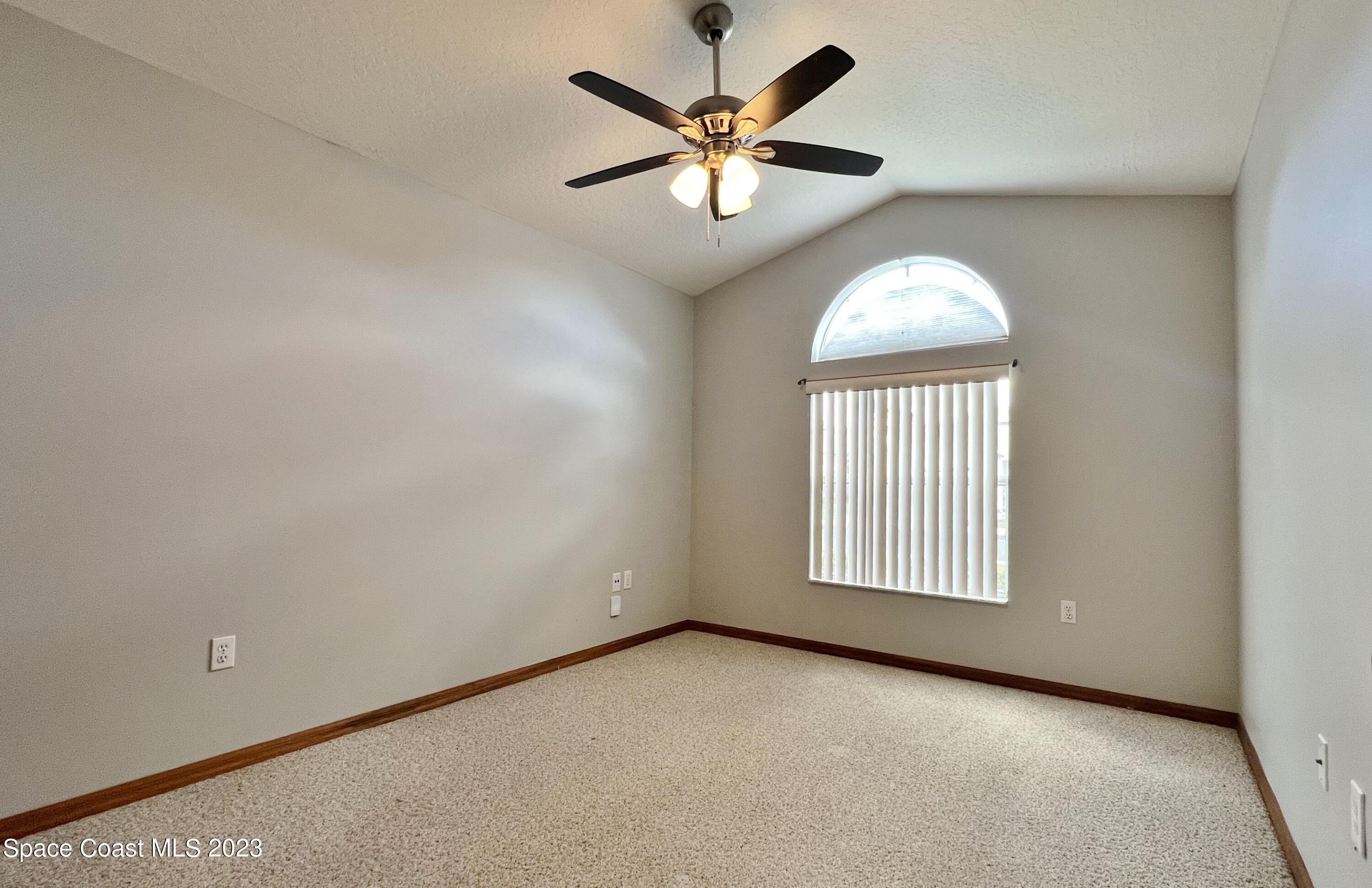 1054 South Fork Circle Melbourne, FL 32901 - Photo 8 of 16 an empty room with windows and fan