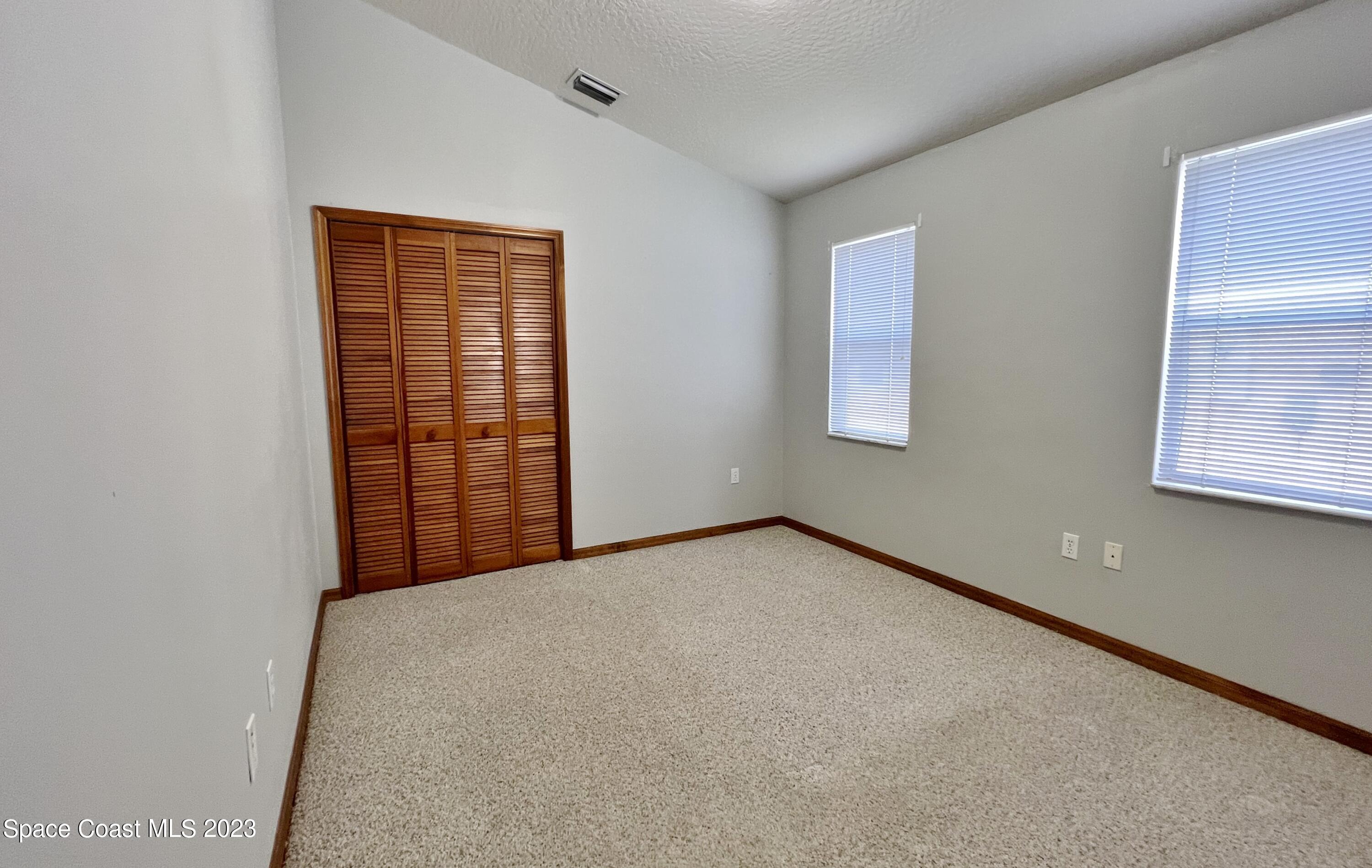 1054 South Fork Circle Melbourne, FL 32901 - Photo 9 of 16 an empty room with windows