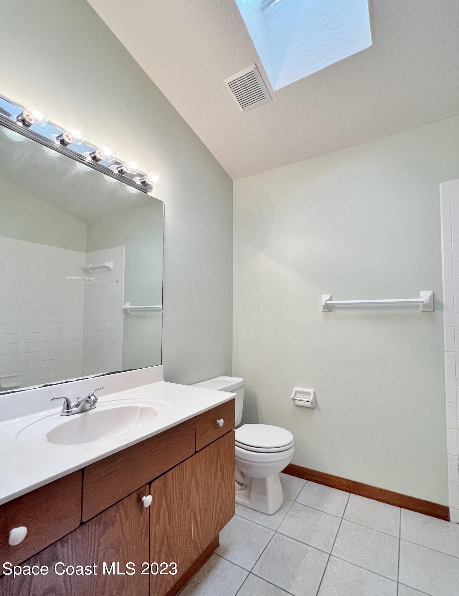 1054 South Fork Circle Melbourne, FL 32901 - Photo 10 of 16 a bathroom with a sink a toilet and a mirror