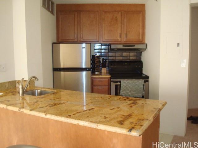 a kitchen with kitchen island sink refrigerator and stove