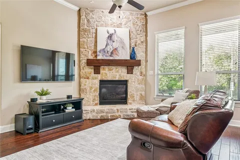 a living room with furniture a flat screen tv and a fireplace
