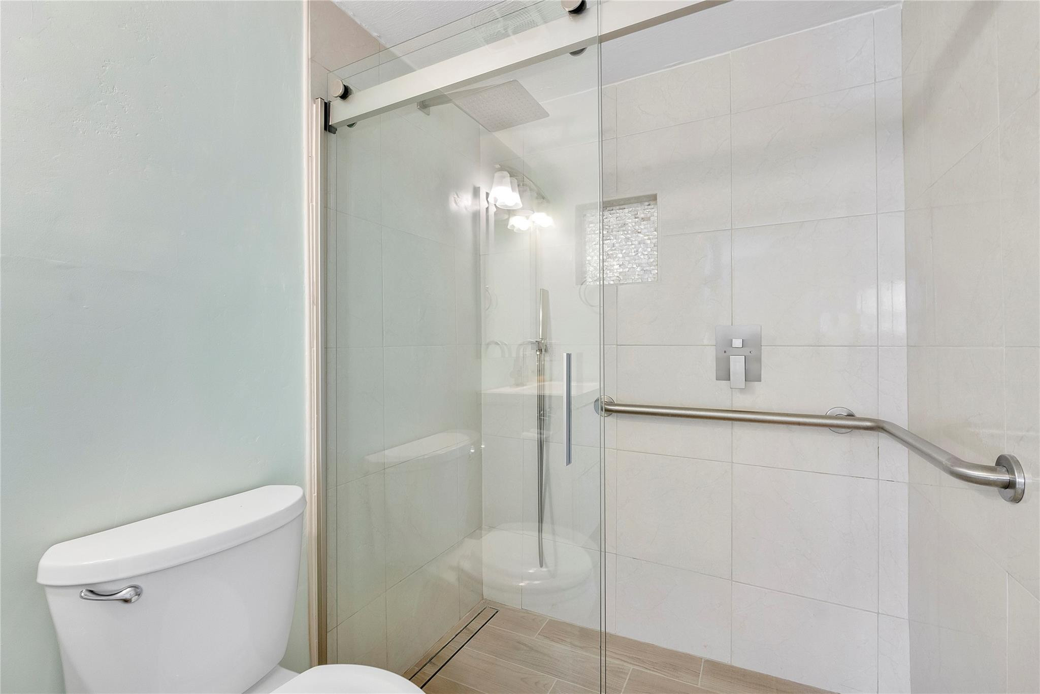 1951 Northeast 39th Street, Unit 156 Lighthouse Point, FL 33064 - Photo 15 of 43 a bathroom with a shower and a toilet