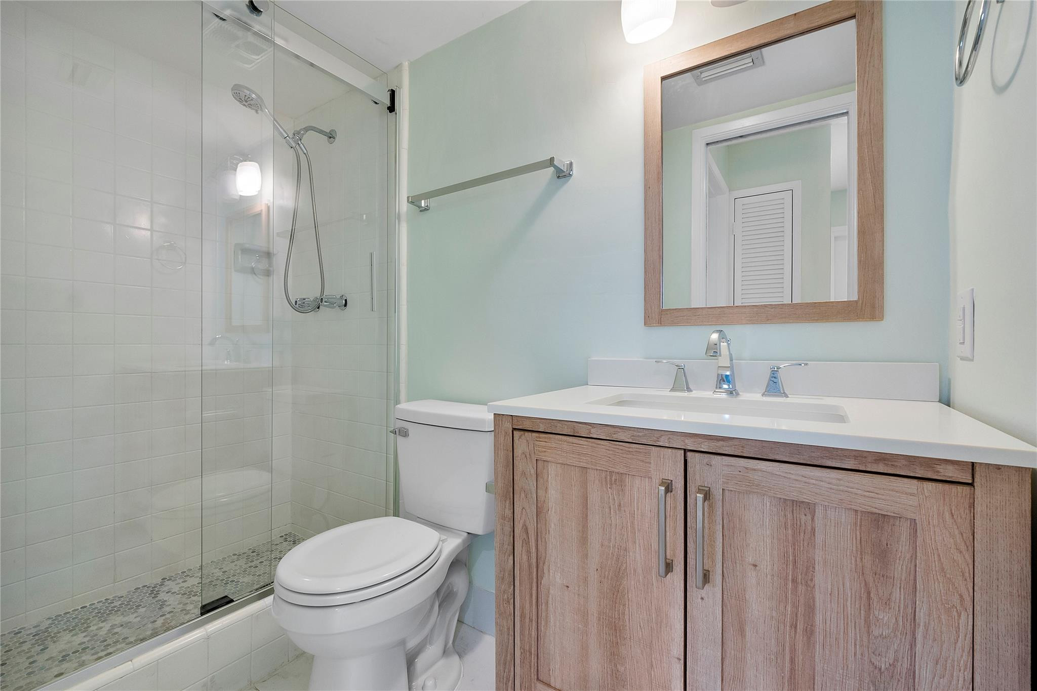 1951 Northeast 39th Street, Unit 156 Lighthouse Point, FL 33064 - Photo 19 of 43 a bathroom with a sink toilet and shower