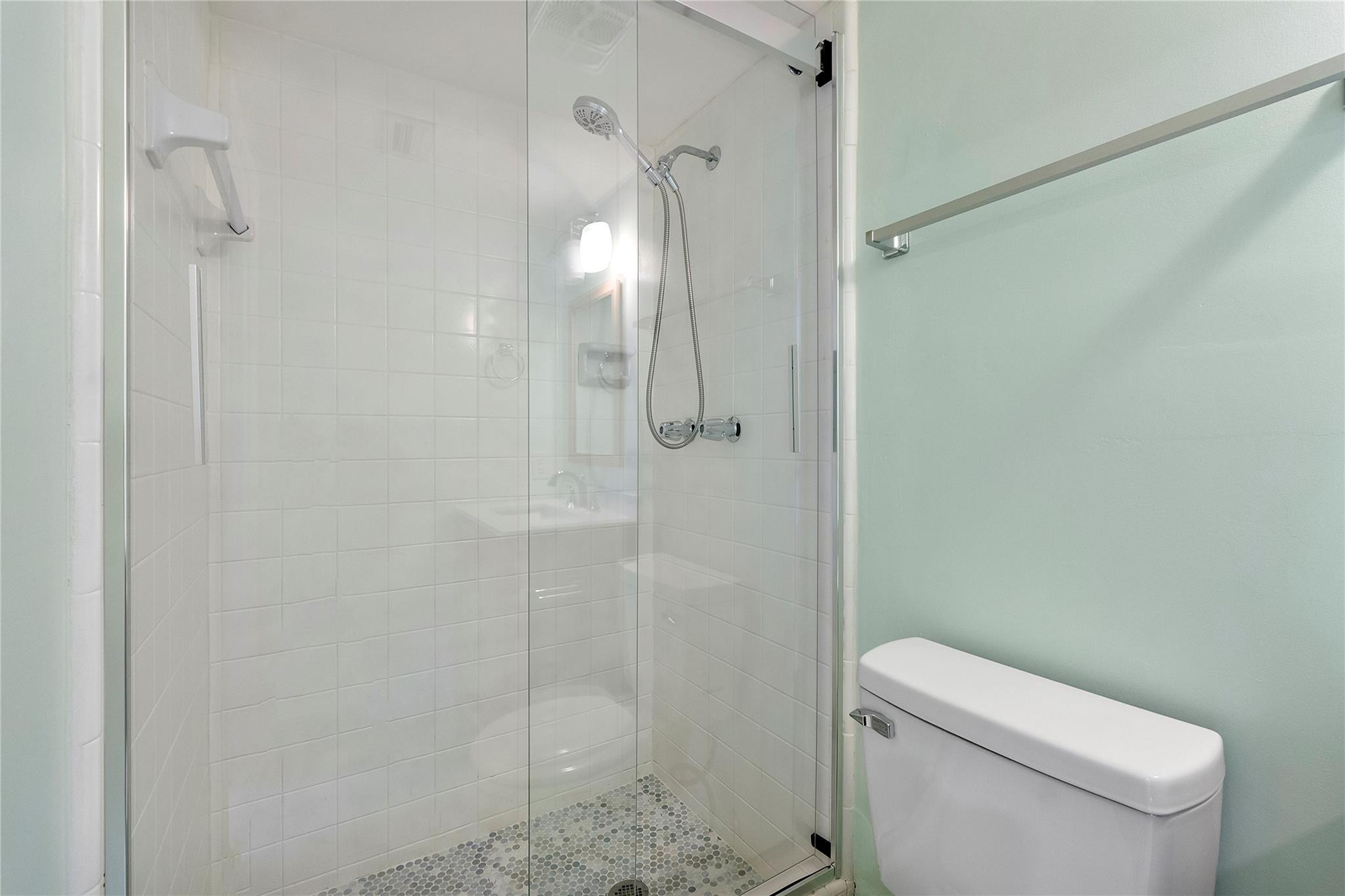 1951 Northeast 39th Street, Unit 156 Lighthouse Point, FL 33064 - Photo 20 of 43 a bathroom with a toilet and shower