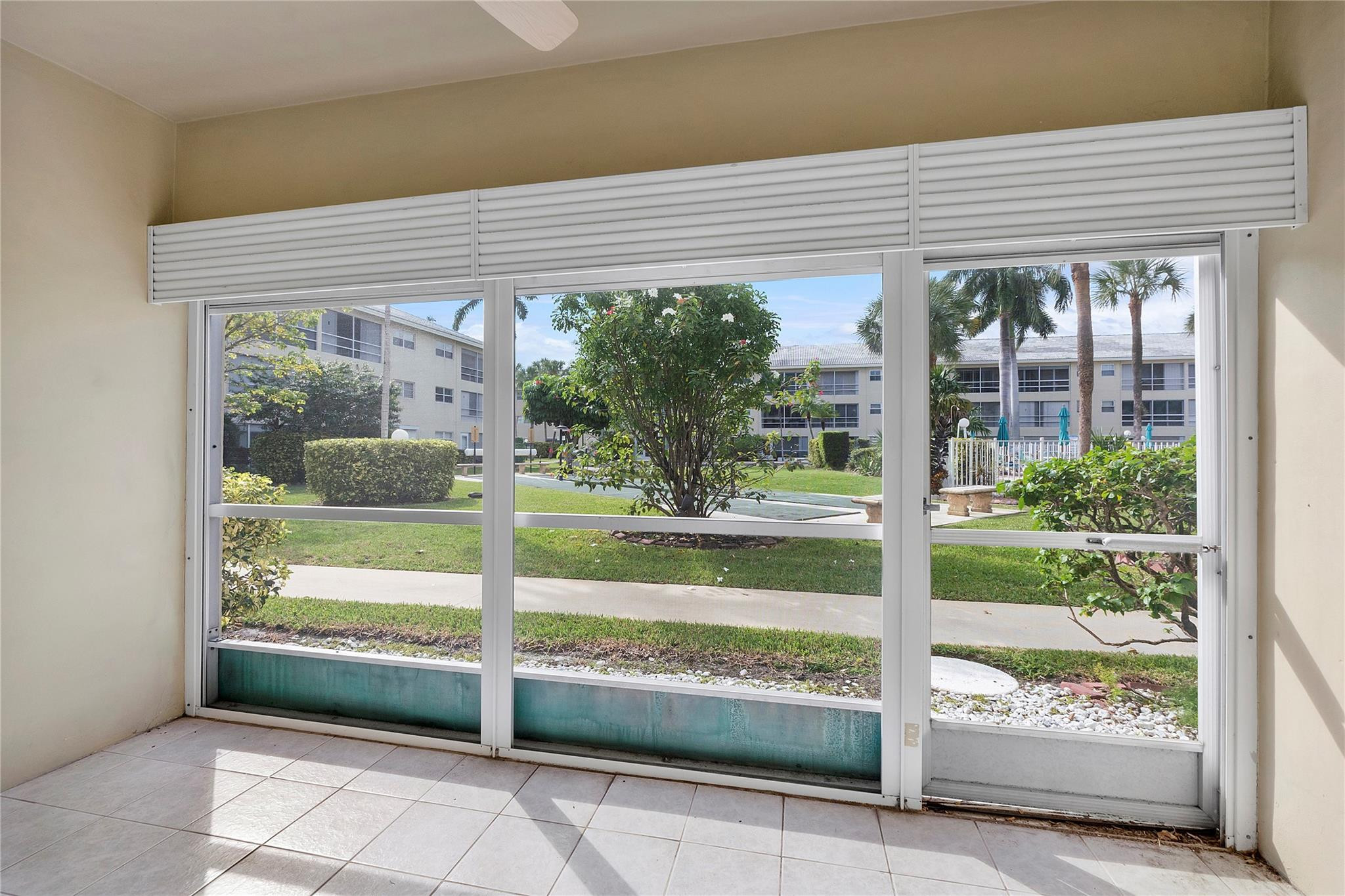 1951 Northeast 39th Street, Unit 156 Lighthouse Point, FL 33064 - Photo 21 of 43 a view of a house with a large window and a yard