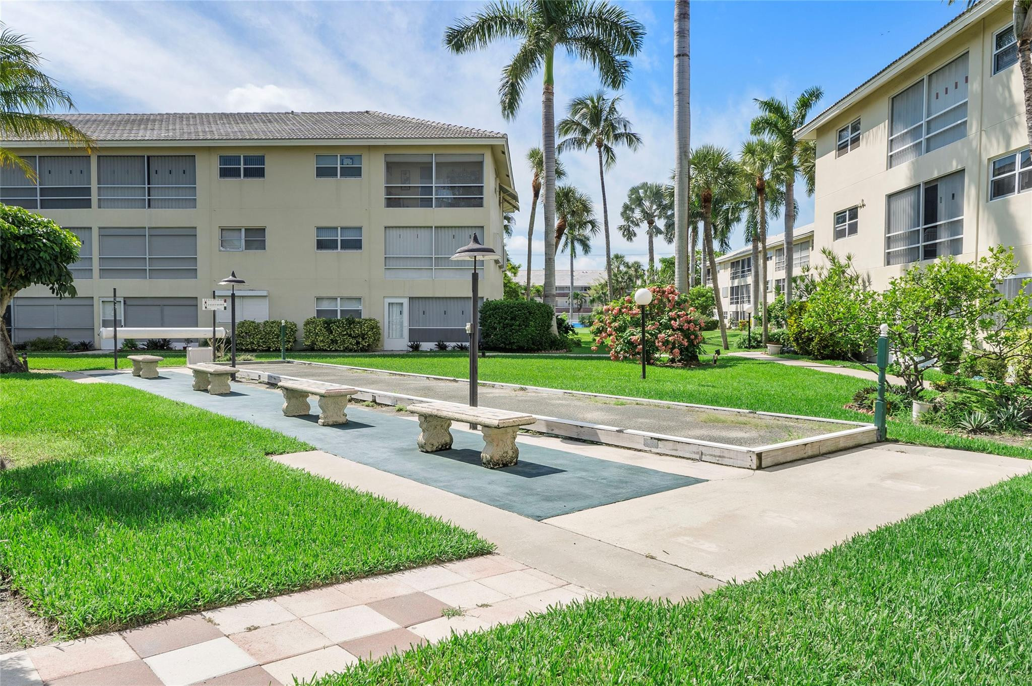 1951 Northeast 39th Street, Unit 156 Lighthouse Point, FL 33064 - Photo 25 of 43 a house with garden in front of it