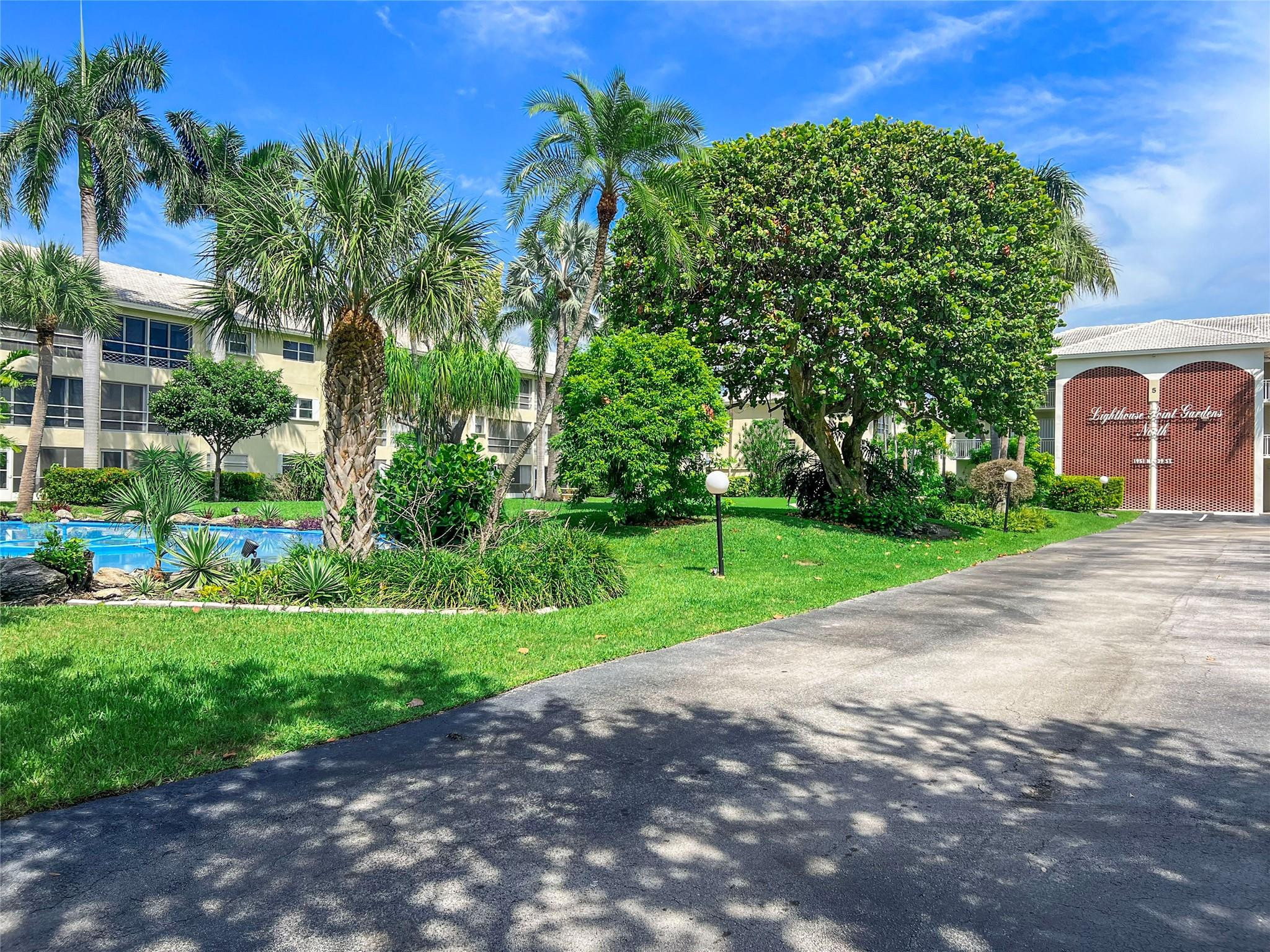 1951 Northeast 39th Street, Unit 156 Lighthouse Point, FL 33064 - Photo 35 of 43 a view of a garden with a pathway