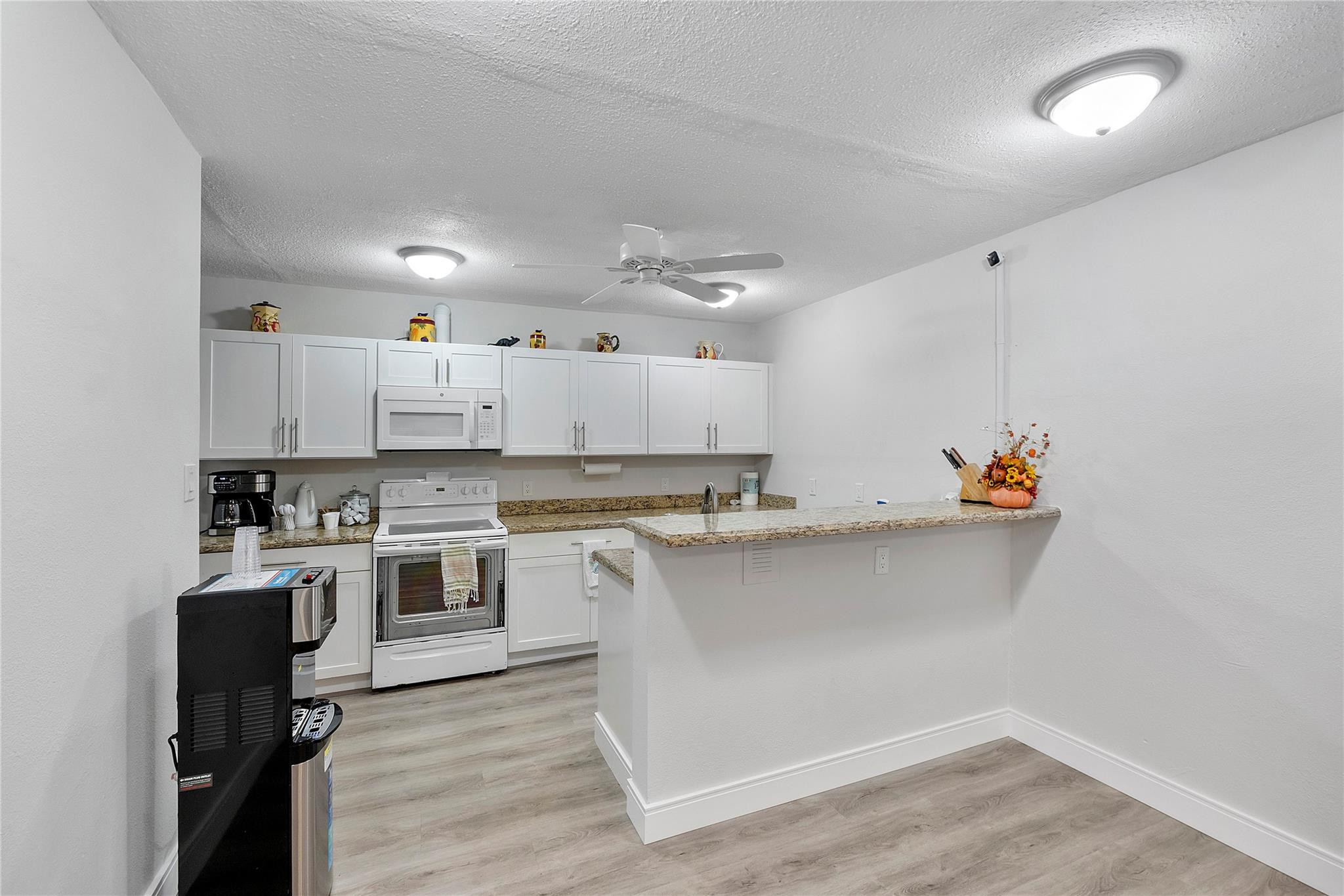 1951 Northeast 39th Street, Unit 156 Lighthouse Point, FL 33064 - Photo 37 of 43 a kitchen with a sink cabinets and window