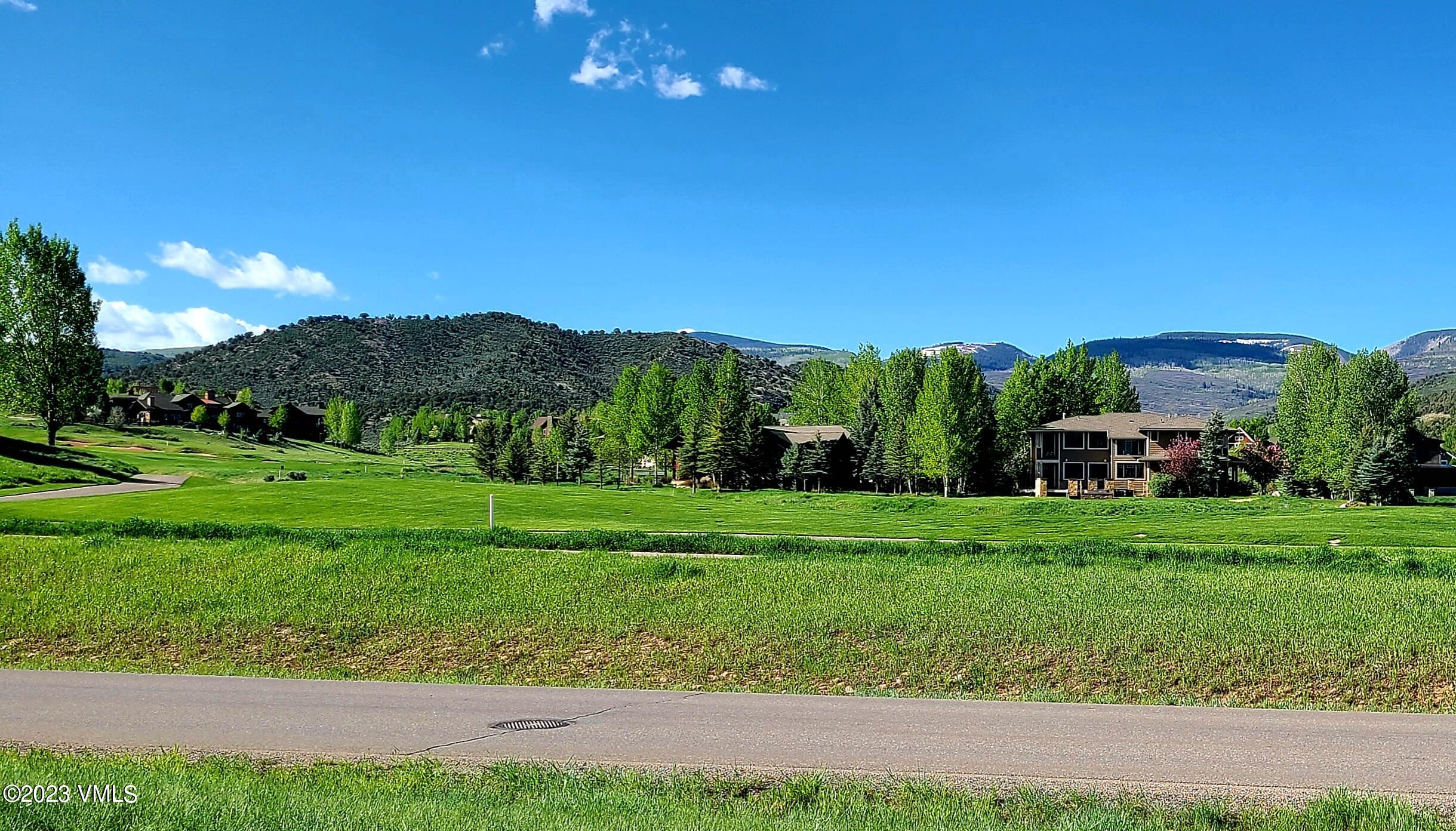 85 East Haystacker Drive Eagle, CO 81631 - Photo 5 of 13 a view of a grassy field with mountains in the background