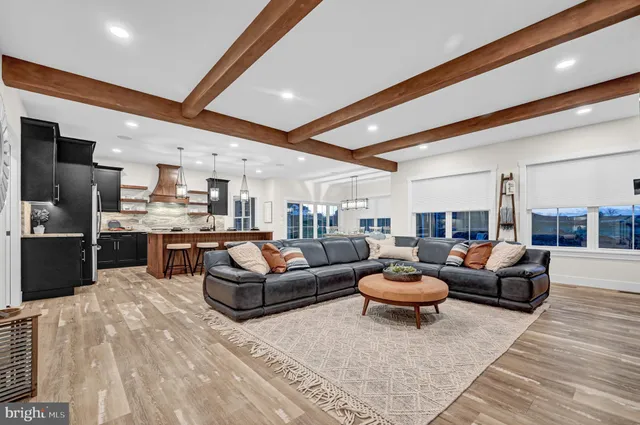 a kitchen with stainless steel appliances granite countertop a sink a stove a counter space and chairs