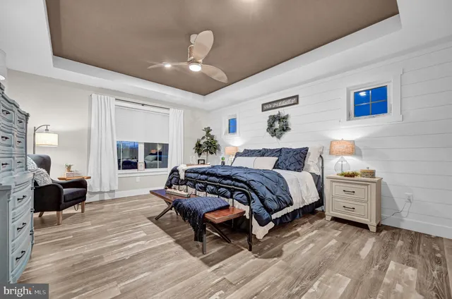 a living room with furniture and a view of kitchen
