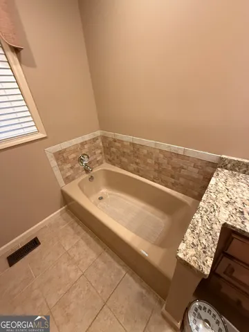 a bathroom with a bathtub and shower