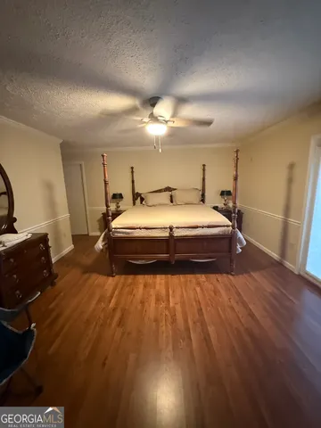 a spacious bedroom with a bed and a dresser