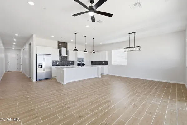 a view of a kitchen with wooden floor and a sink