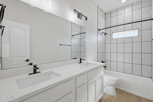 a bathroom with a sink toilet a mirror and shower