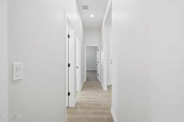 a view of a hallway with wooden shelves