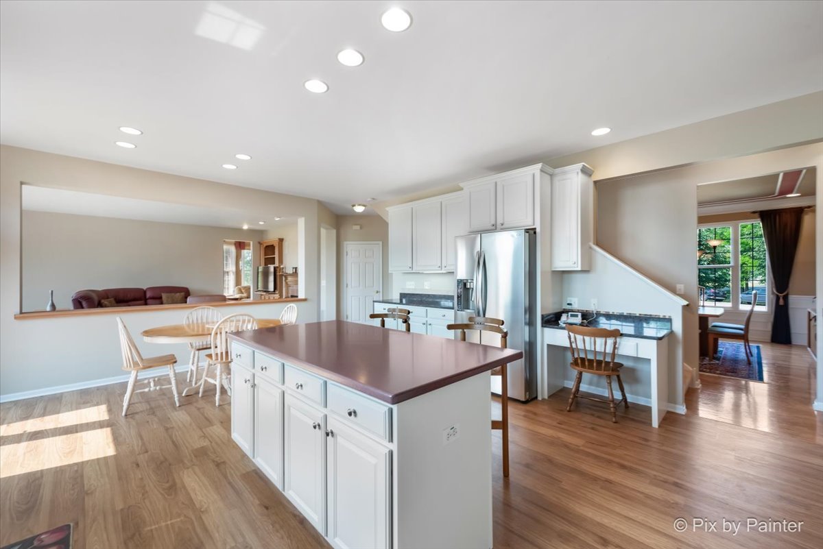 8475 Watson Circle Lakewood, IL 60014 - Photo 14 of 49 a kitchen with stainless steel appliances granite countertop a refrigerator and a stove top oven