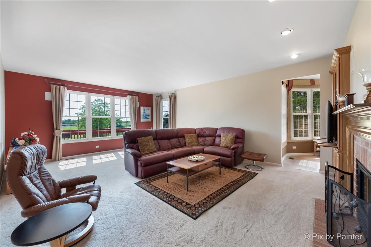 8475 Watson Circle Lakewood, IL 60014 - Photo 18 of 49 a living room with furniture a flat screen tv and a large window