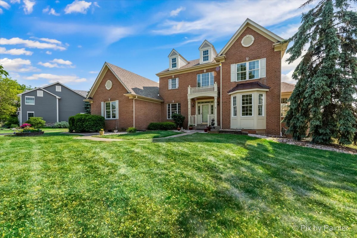 8475 Watson Circle Lakewood, IL 60014 - Photo 2 of 49 a front view of a house with a yard