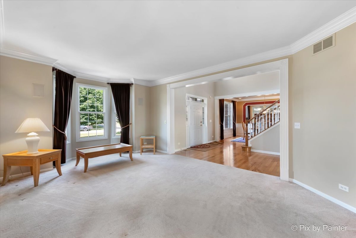 8475 Watson Circle Lakewood, IL 60014 - Photo 21 of 49 a view of an empty room with window a ceiling fan and wooden floor