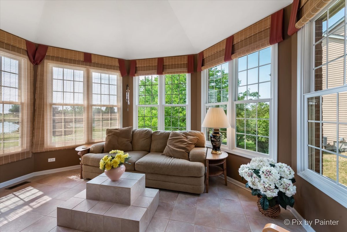 8475 Watson Circle Lakewood, IL 60014 - Photo 22 of 49 a living room with furniture and floor to ceiling windows