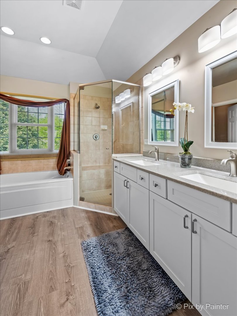 8475 Watson Circle Lakewood, IL 60014 - Photo 27 of 49 a spacious bathroom with a double vanity sink a mirror and a shower
