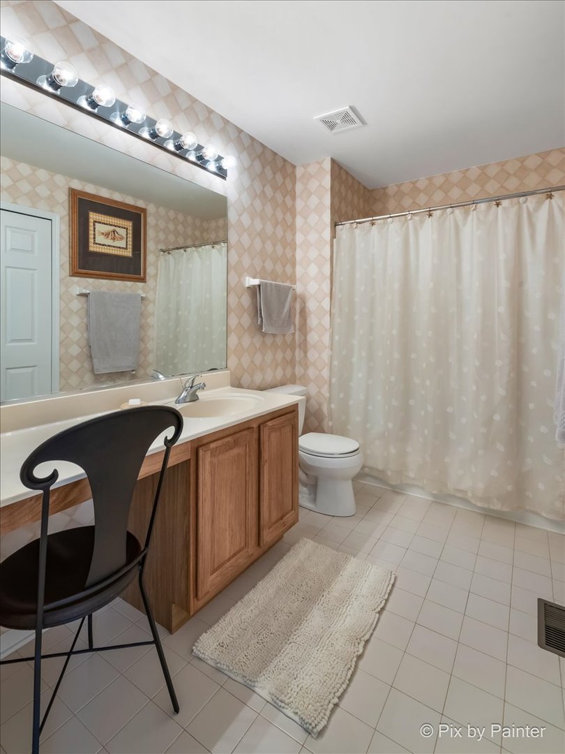 8475 Watson Circle Lakewood, IL 60014 - Photo 31 of 49 a spacious bathroom with a double vanity sink and a mirror