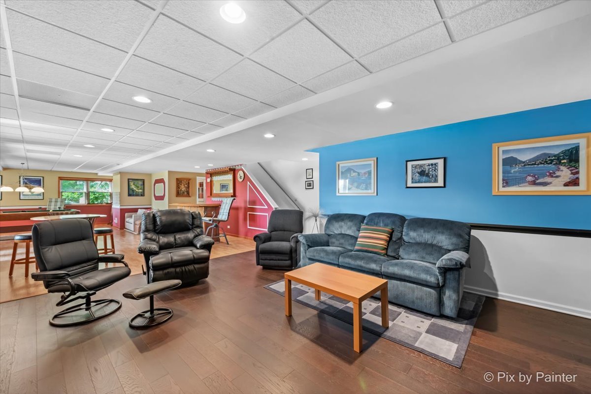 8475 Watson Circle Lakewood, IL 60014 - Photo 33 of 49 a living room with furniture a flat screen tv and gym equipment