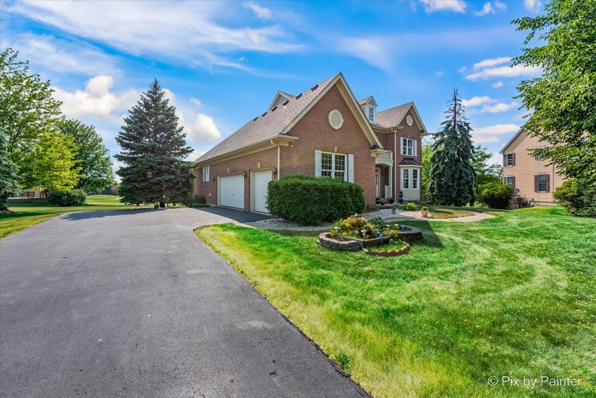 8475 Watson Circle Lakewood, IL 60014 - Photo 39 of 49 a front view of a house with garden